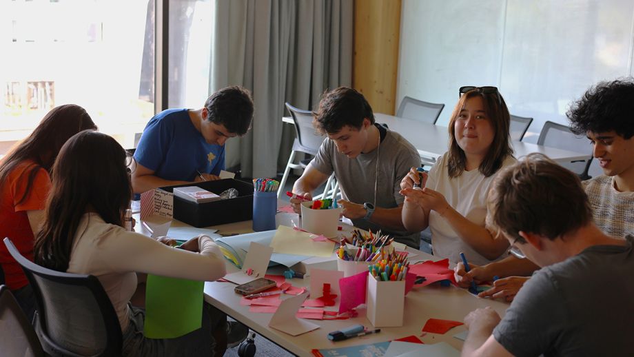 Few students writing words on papers