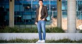 Full length shot of Sergey. he's facing the camera with one hand in his jeans pocket. 
