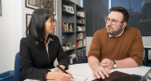 Associate Professor Nhung Nghiem and Professor Mark Polizzotto sit at a desk looking at one another