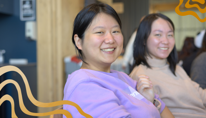 2 students looking at the camera smiling